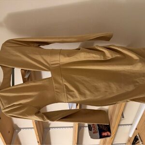 Goldish yellow dress with the open back in the low cleavage